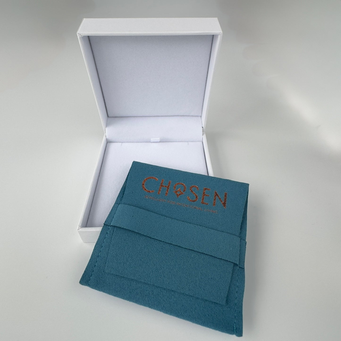 Teal envelope with ‘Chosen' text in a white box on a light gray background