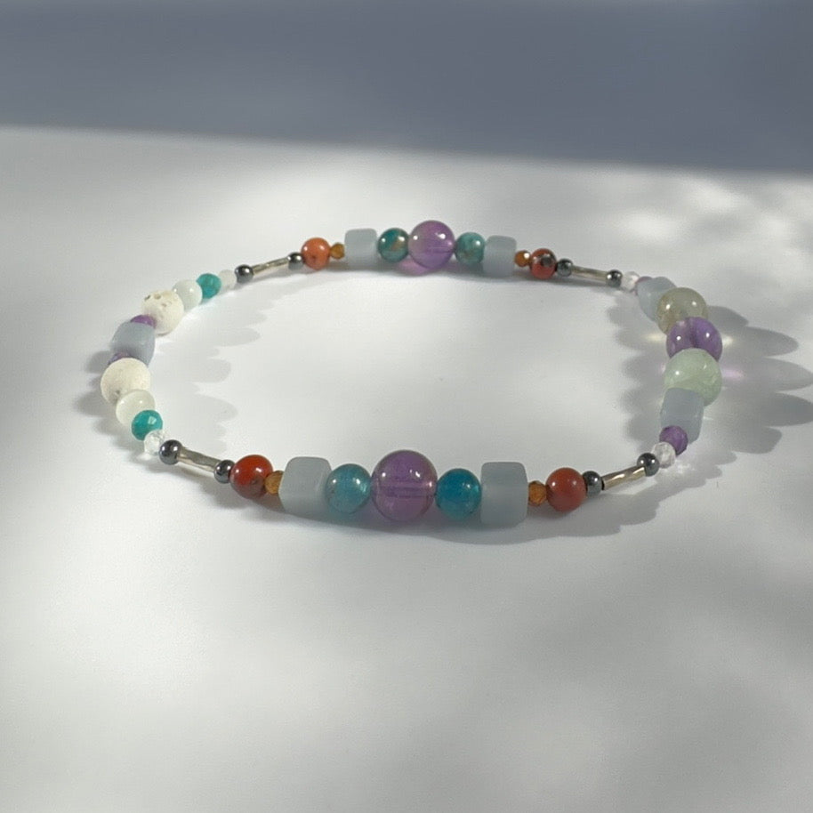 Beaded bracelet in purple blue and red tones