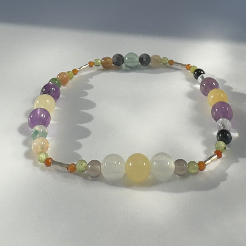 Beaded bracelet in yellow green and purple tones