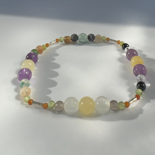 Beaded bracelet in yellow green and purple tones