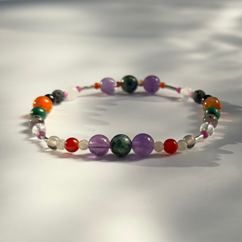 Beaded bracelet in shades of purple green and orange