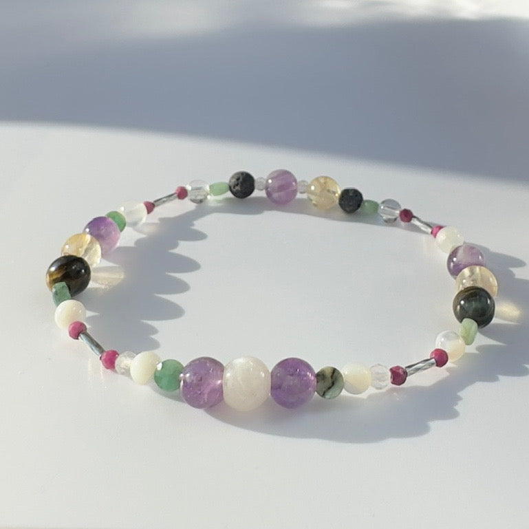 Beaded bracelet in shades of purple yellow and white