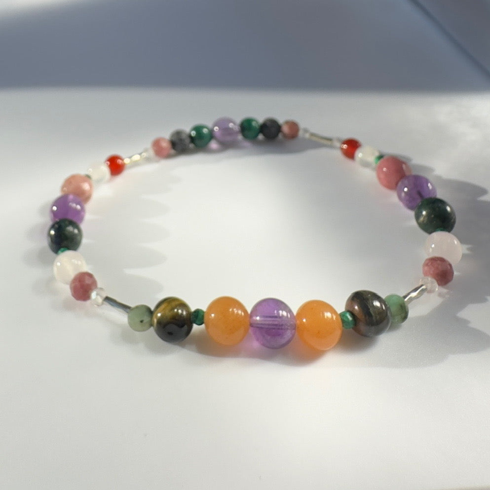 Beaded bracelet in tones of orange purple and green