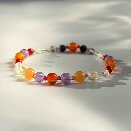 Beaded bracelet in shades of red orange and purple