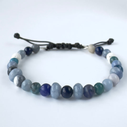 Beaded bracelet in shades of blue and white stones on a white background