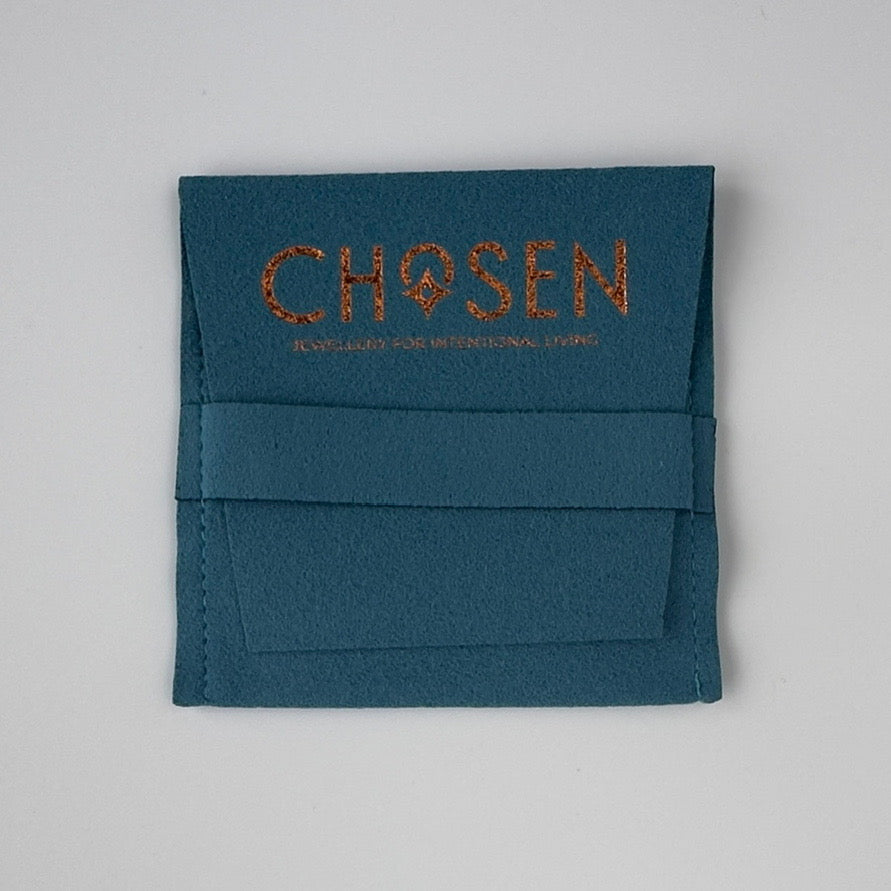 Teal fabric pouch with 'CHOSEN' branding on a light gray background