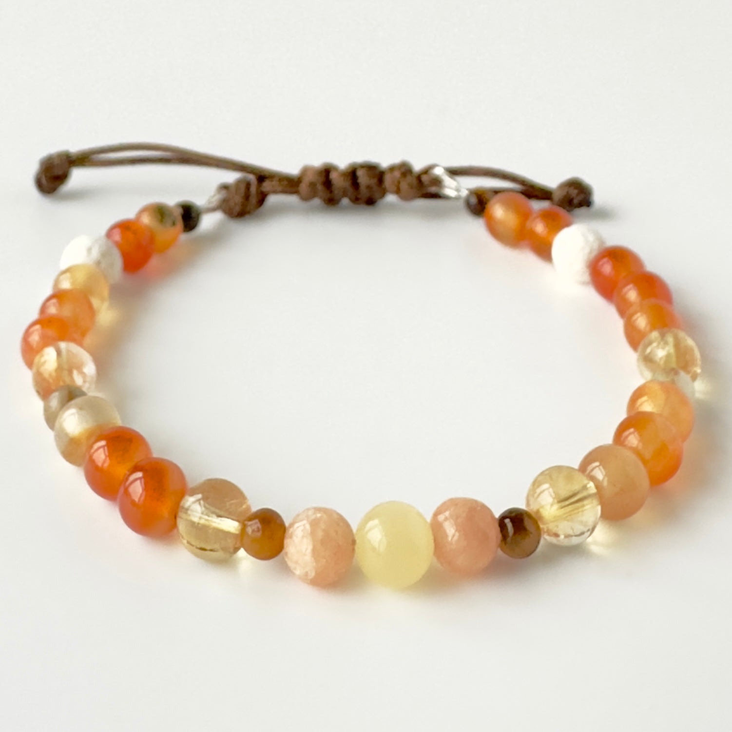 Beaded bracelet in tones of yellow and orange on a white background