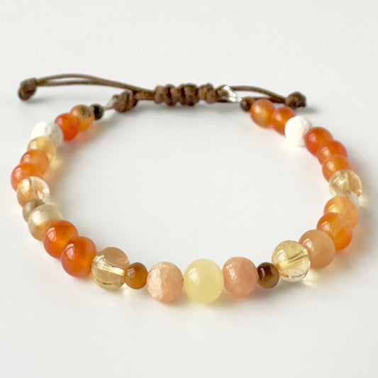 Beaded bracelet in tones of yellow and orange on a white background