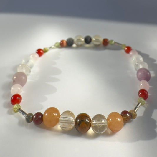 Beaded bracelet in orange yellow and pink tones