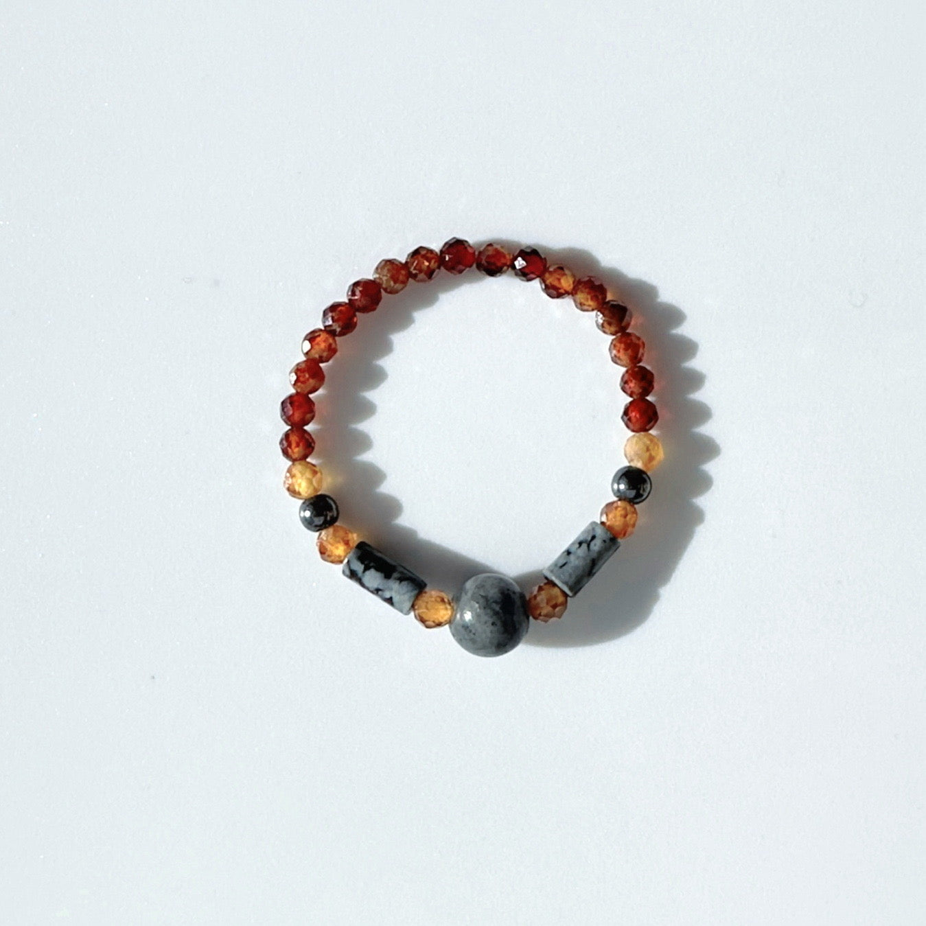 Beaded ring with multicolored beads on a white background