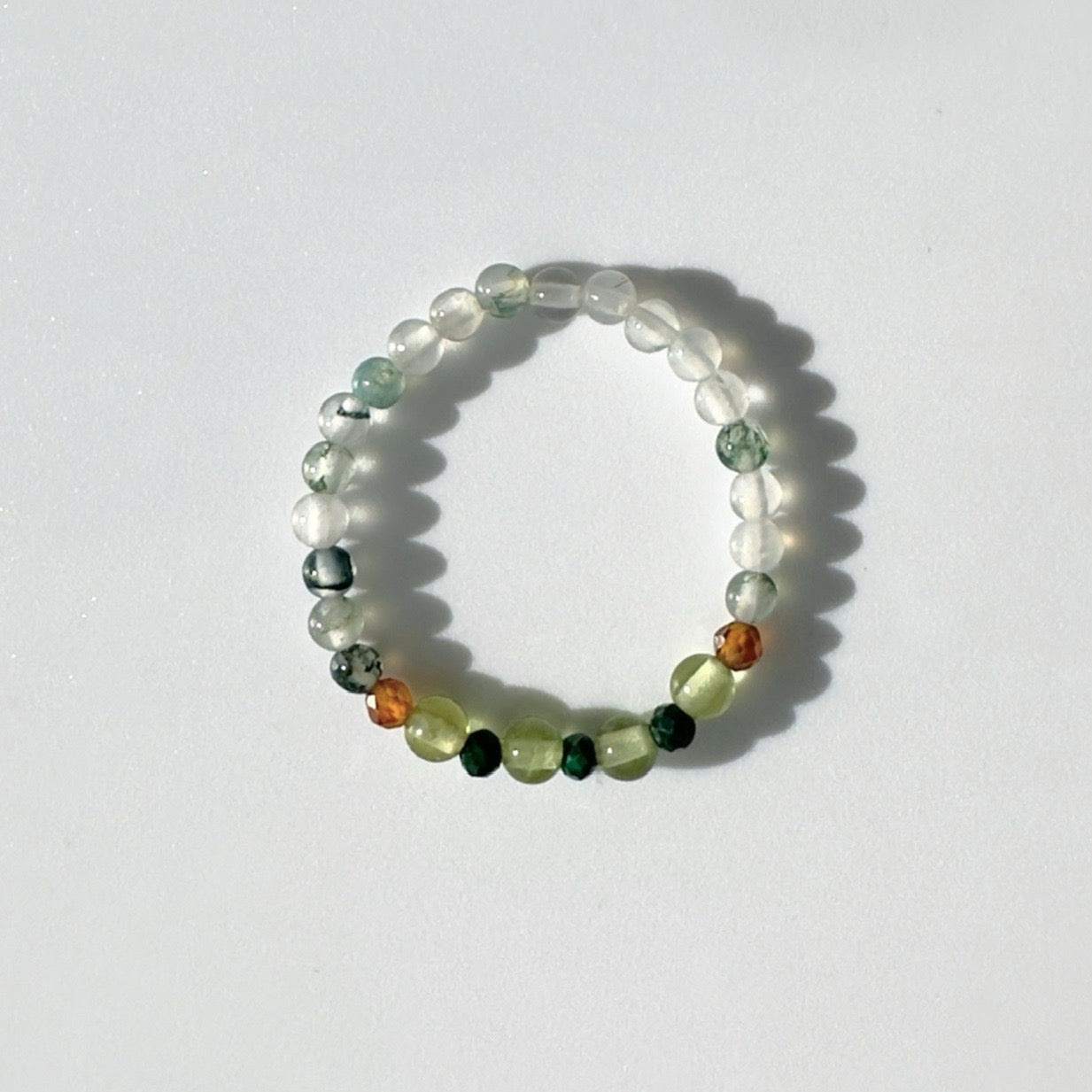 Beaded ring with multicolored beads on a white background
