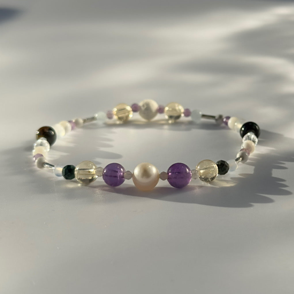 Beaded bracelet in shades of purple yellow and cream