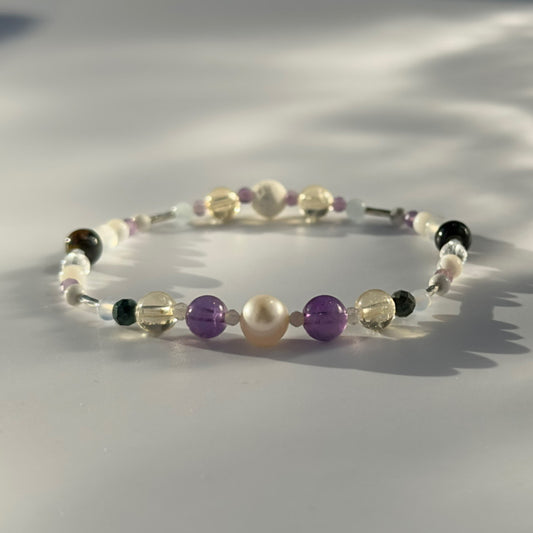Beaded bracelet in shades of purple yellow and cream
