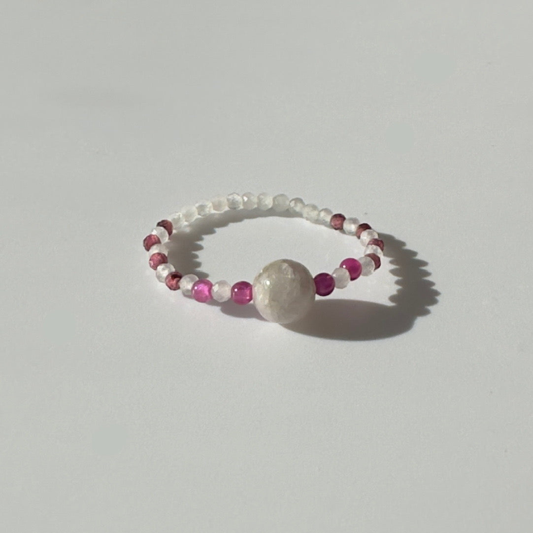 Red and pink beaded ring with large cental pale pink stone